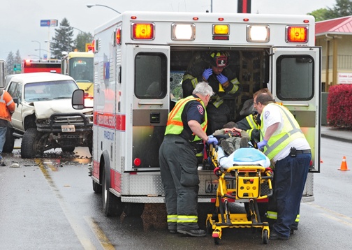 Brandon Swanson / bswanson@chronline.com
First responders lift a man into an ambulance after he was involved in a car accident on Harrison Avenue in Centralia Wednesday.